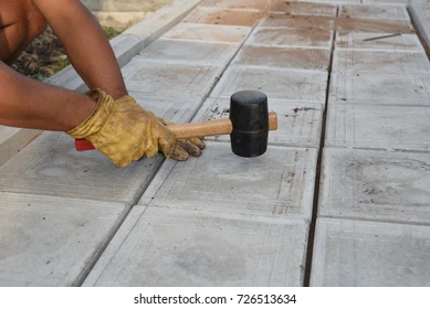 man-rubber-mallet-taps-tiles-260nw-726513634